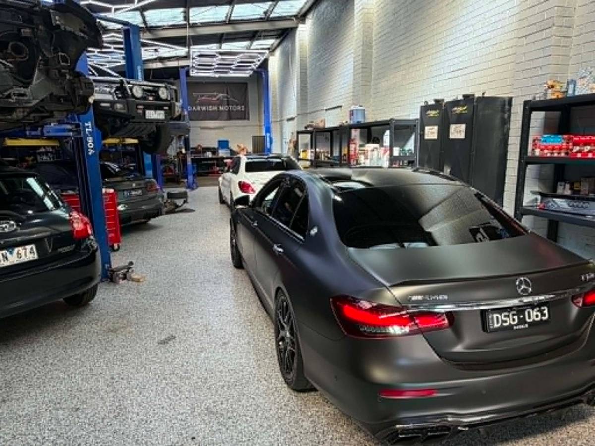 Inside the Darwish Motors workshop: cars on the two-post hoists with a matte-black Mercedes-Benz E63 parked alongside